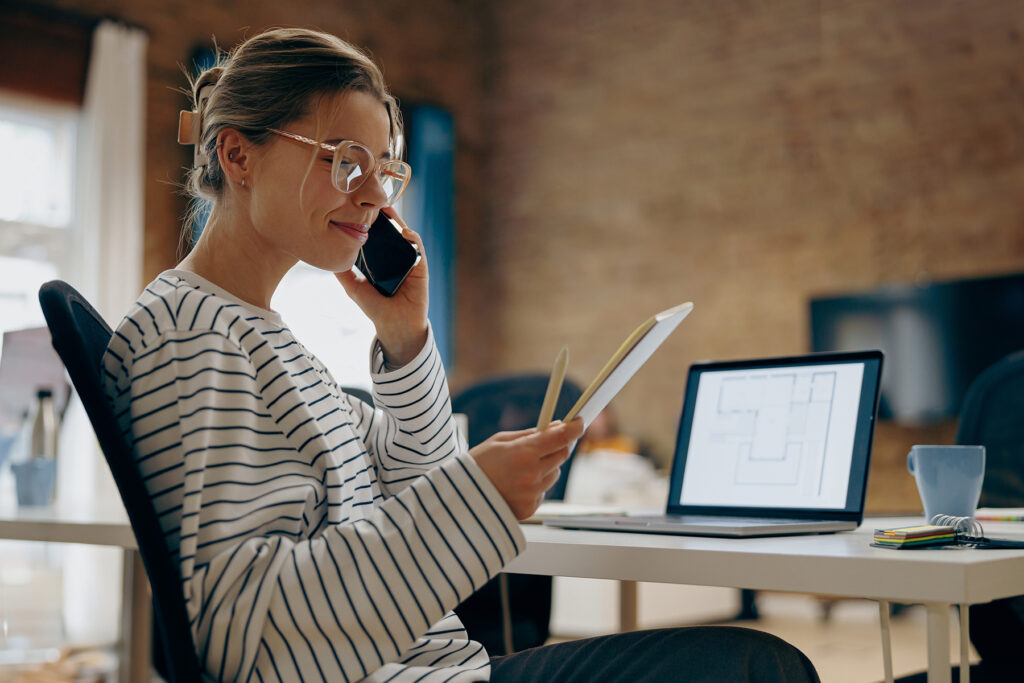 Woman talking to a client in an office and taking notes